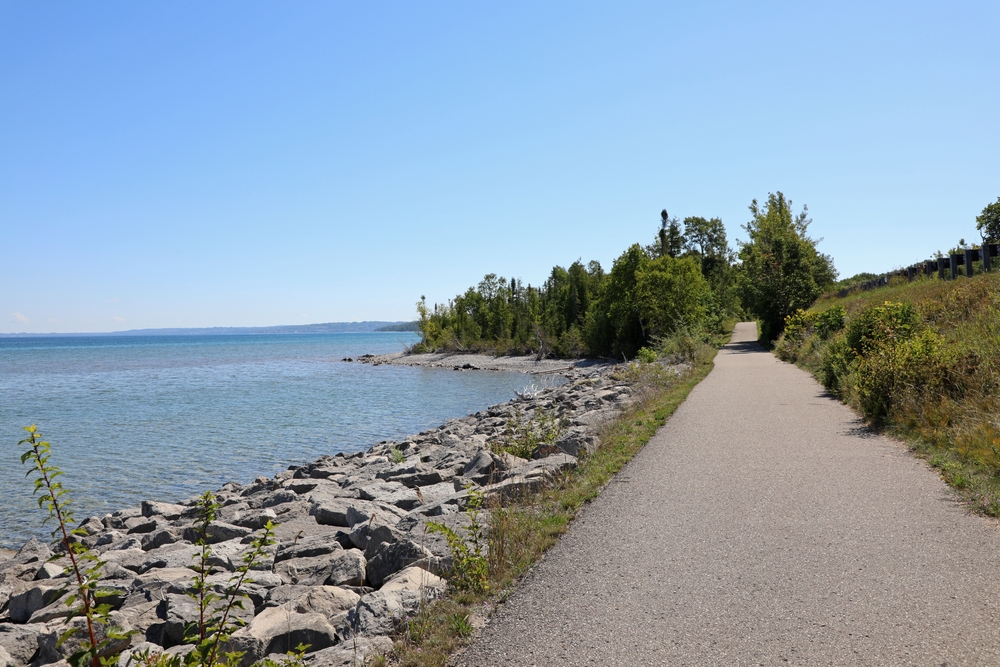Foot path that stretches from Traverse to Harbor Springs pictured on a clear day on Lake Michigan during the best time to visit Tunnel of Trees