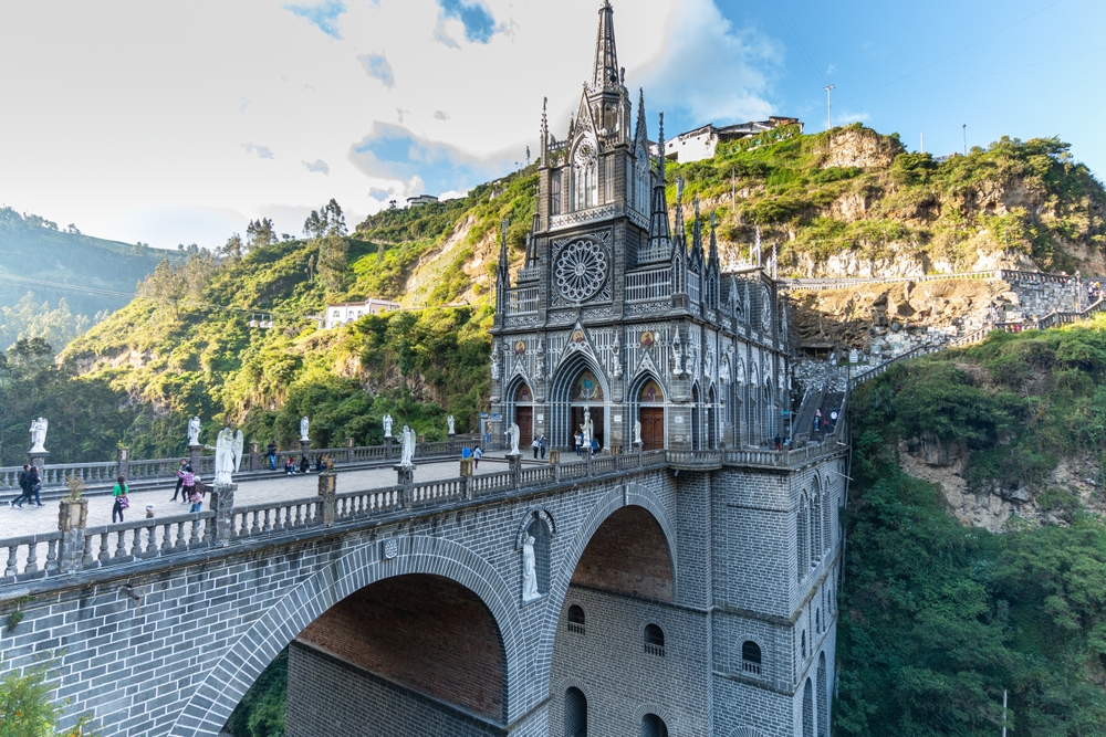 Breathtaking view of the stunning Las Lajas Sanctuary, one of the best places to visit in Colombia, pictured with the cathedral on the cliff towering over the river below