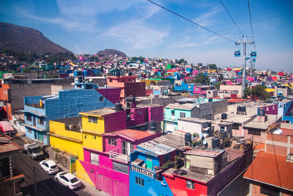 For a piece titled Is Mexico City Safe to Visit, a photo of the barrio of Iztapalapa pictured with skylifts overhead