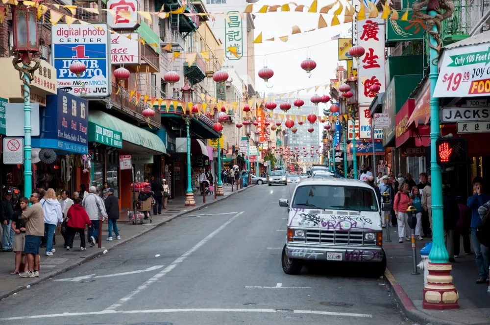 Van outside a restaurant under red paper lanterns in Chinatown