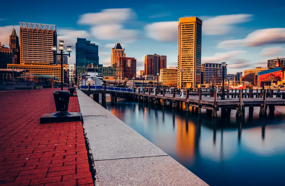 Edited photo of the Inner Harbor, a top pick for where to stay in Baltimore, pictured with still water and the city's skyline jutting up from above the water