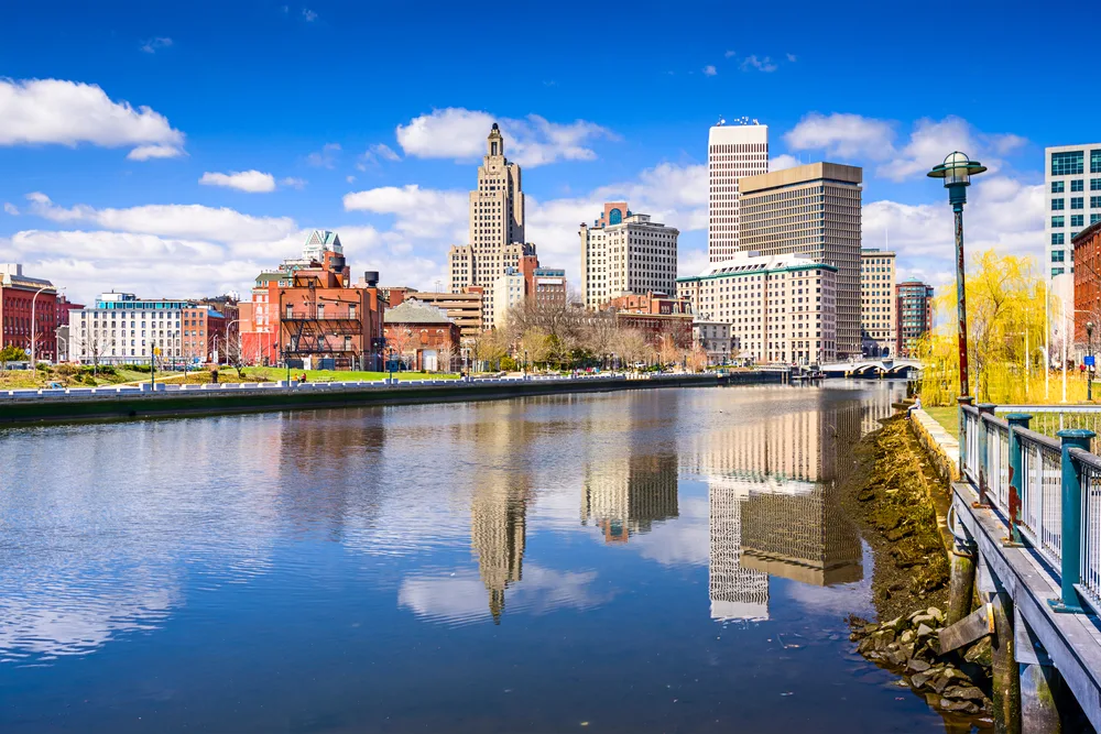 Still water in Providence, Rhode Island, a top pick for the best places to visit in the Northeast, pictured with the downtown buildings overlooking the lake