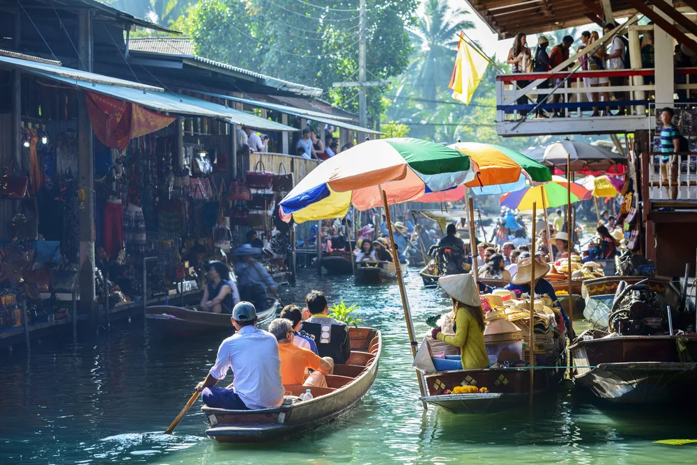 Boats float along the water in the Damnoen Saduak Floating Market in Bangkok