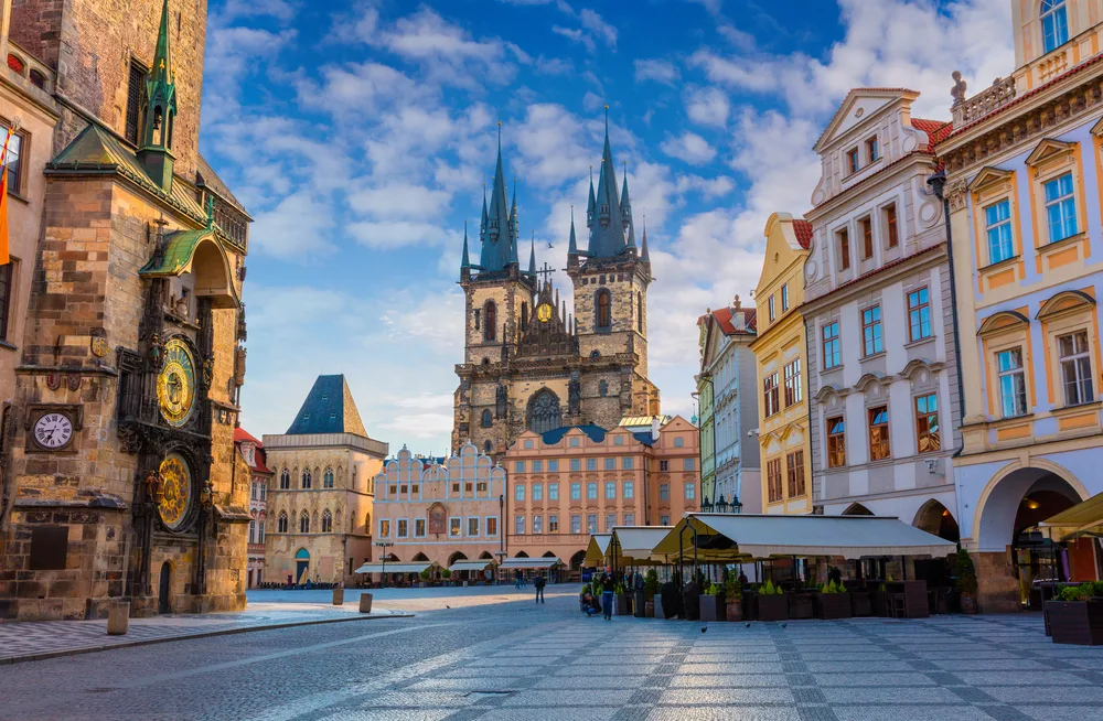 Sunday morning in the old town square with Tyn Church towering over the scene in Prague, one of the best places to visit in Europe