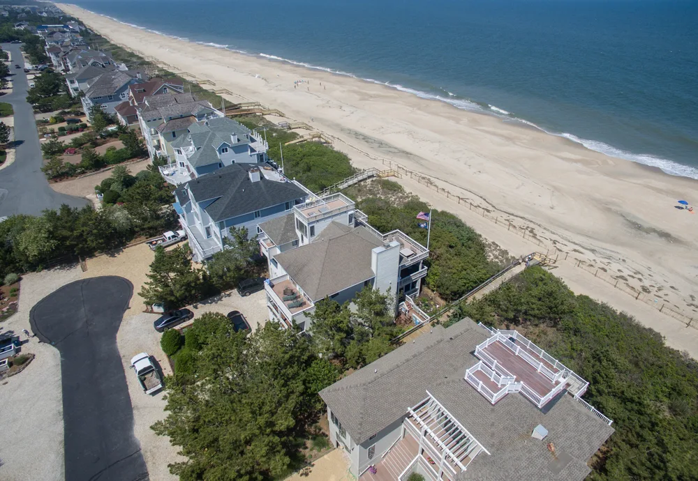 Aerial view of Dewey Beach, one of the best places to visit in Delaware, as seen from above a home looking down the coastline