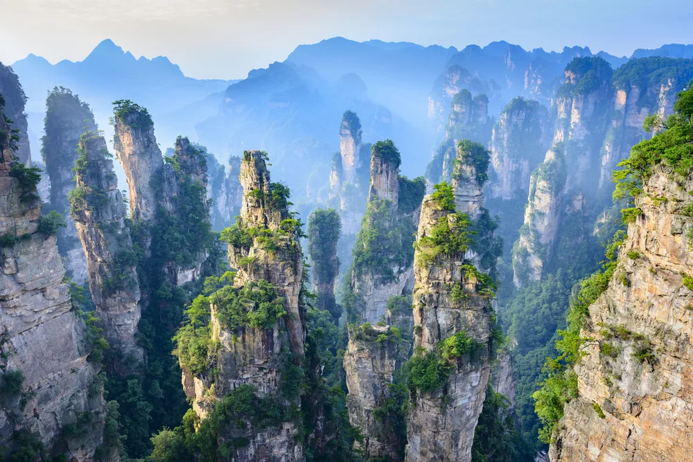 Mist over and between the unique rock formations in Zhangjiajie, one of our favorite places to visit in China