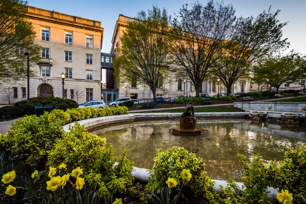 Garden, fountains, and old buildings in the town square in Mount Vernon, a top pick when considering where to stay in Baltimore, Maryland