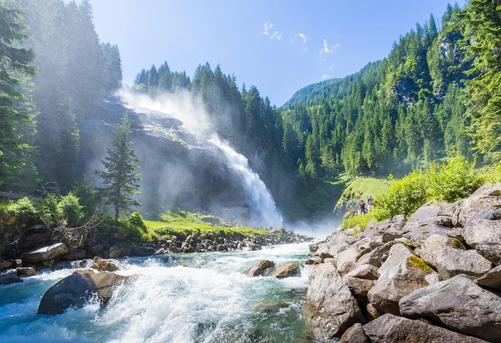 Stunning view of the Krimml Waterfalls, one of the best places to visit in Austria, as seen on a clear day with mist abounding
