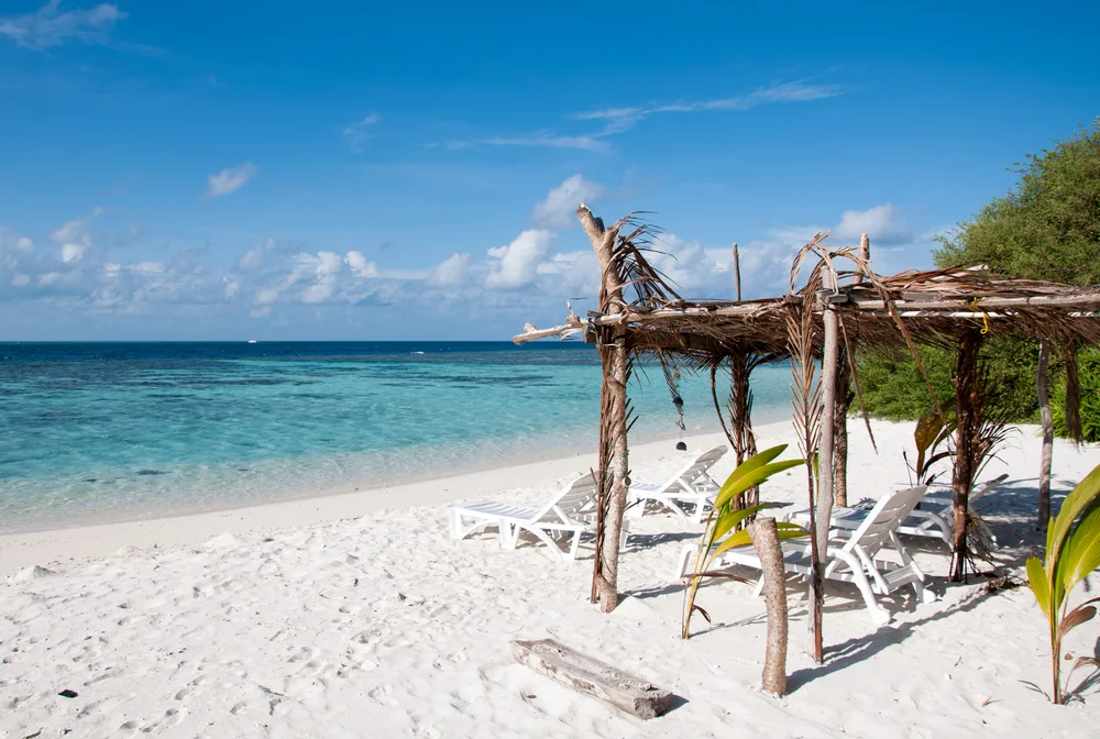 Thinadhoo Island sun lounger on the beach showing one of the best islands in the Maldives for tourists