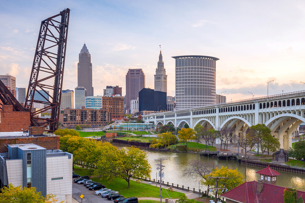 Lots going on in the downtown area of Cleveland, one of the best places to visit in the Midwest, with a drawbridge pulled up and a long bridge leading to skyscrapers downtown
