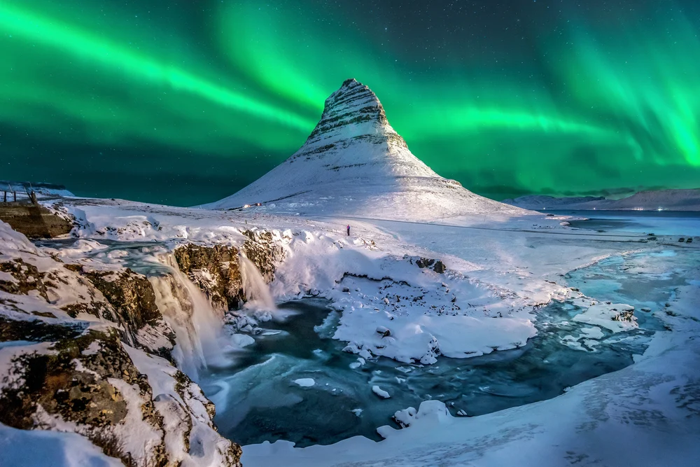 Northern lights above Mount Kirkjufell in Iceland, pictured for a guide to the best places to visit in iceland
