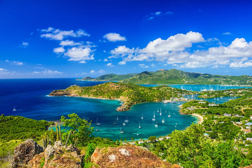 Aerial view of Shirley Heights in Antigua, one of the best islands in the Caribbean to visit with clouds in the sky and sailboats on the water