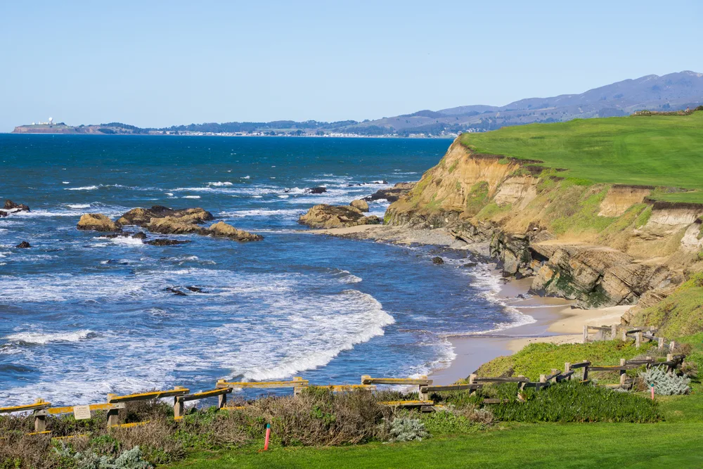 Pacific coastline of Half Moon Bay pictured with water crashing up against the rocky coast