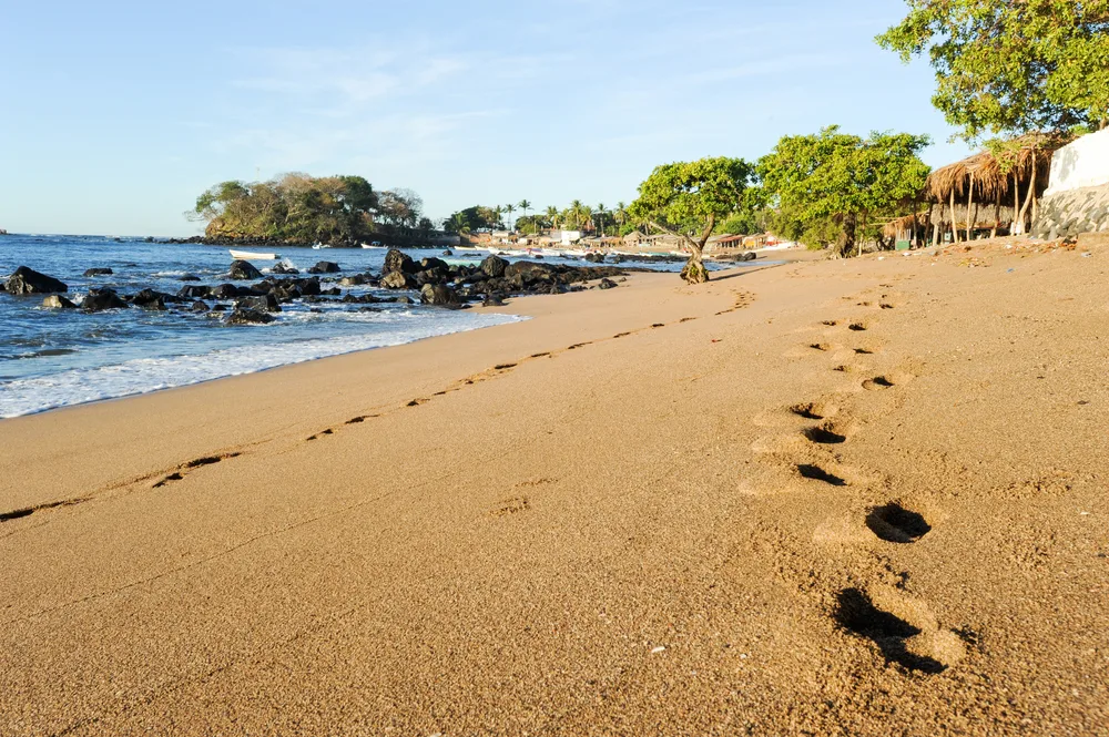 Deep footprints left in the sand of Los Cobanos beach in an El Salvadoran fishing village and beach town that stands out as one of the best places to visit in the country