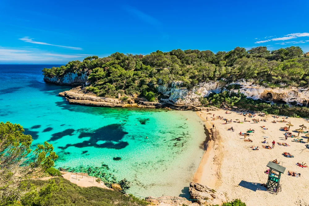 Secluded beach surrounded by rock formations on the Majorca Cala Llombards Santanyi beach in Mallorca in the Balearic Islands, one of our top picks for places to visit in Spain