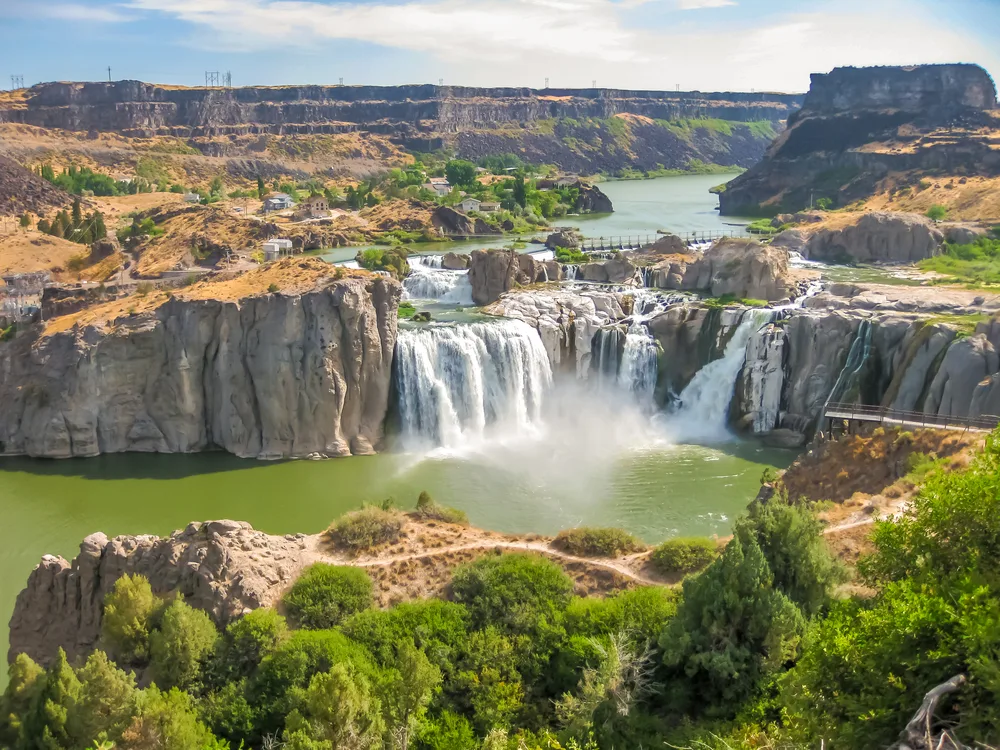 Spectacular aerial view of the Shoshone Falls, one of the best places to visit in Idaho, with the magnificent water cascades pouring over the jagged rock face