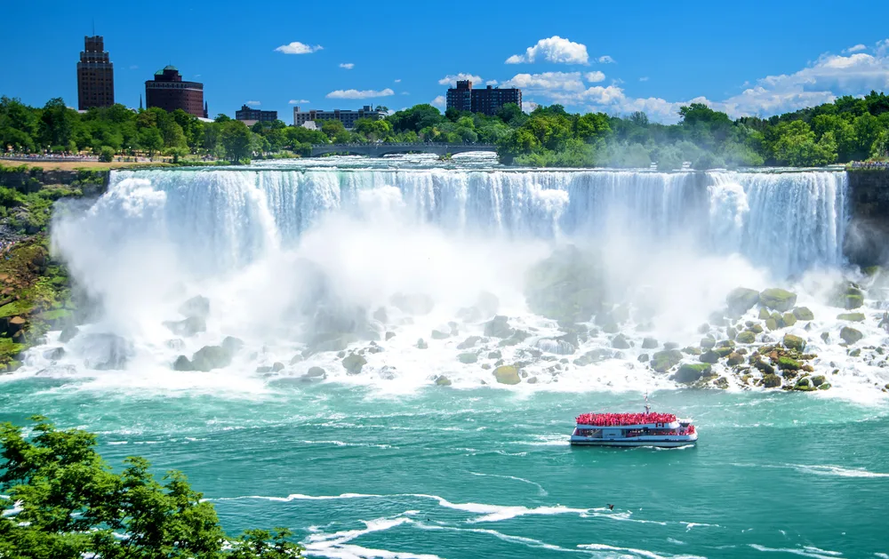 Amazing view of the Lady of the Mist pictured floating by Niagara Falls, one of the best places to visit in the Northeast
