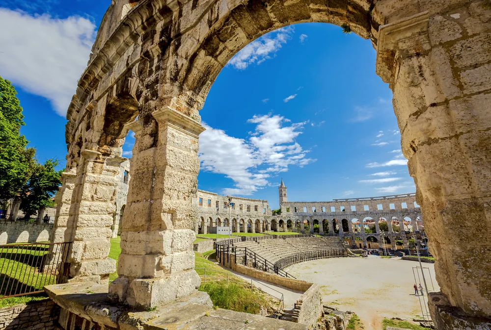 Colosseum at Pula, one of the best places to visit in Croatia, pictured against a blue sky