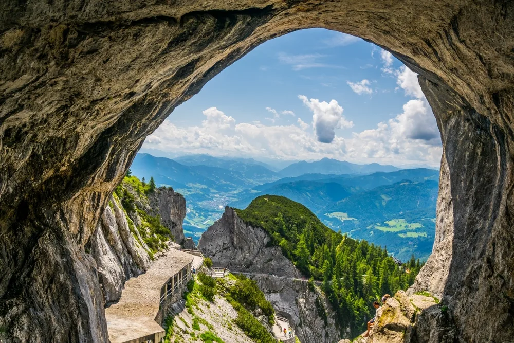 View from the Eisriesenwelt Cave in Austria looking out toward the Alpls and the footpath leading to the entrance on a sunny day