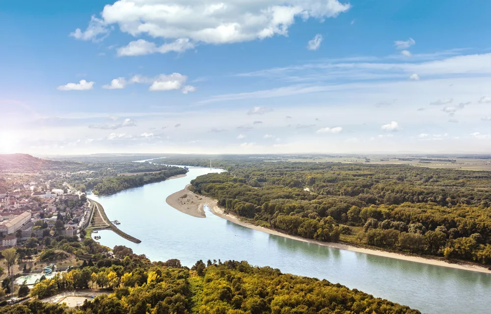 Aerial view of one of the best places to visit in Austria, National Park Donau-Auen, seen with the river winding through the trees
