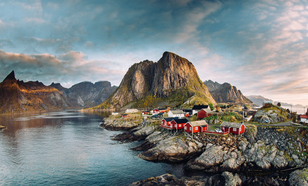 As a featured place to visit in Switzerland, a bunch of red homes on the rocks in the Lofoten Islands
