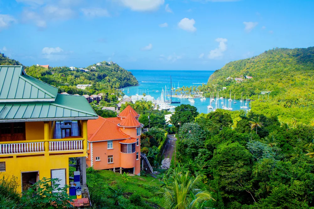 Wide view of St. Lucia island with colorful houses and Caribbean Sea in the distance for a piece covering the best islands in the Caribbean
