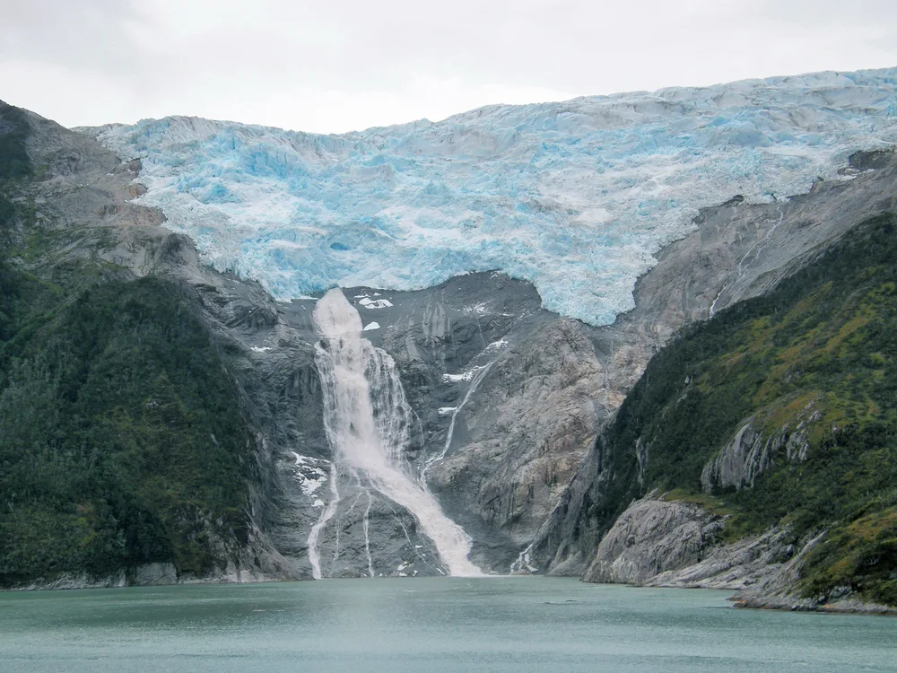 For a piece on the best places to visit in Chile, a photo of a massive glacier by the Chilean Fjords pictured on a gloomy day