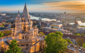 Budapest skyline and Danube River at sunrise showing Fisherman's Bastion and green trees during the best time to visit Hungary