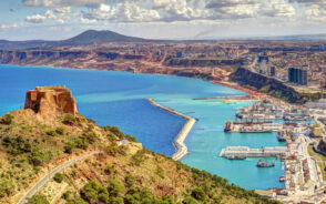 Oran aerial view with blue waters along the coast and mountains in the distance during the best time to visit Algeria