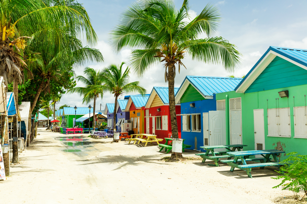 Colorful homes in Barbados pictured along a sandy beach