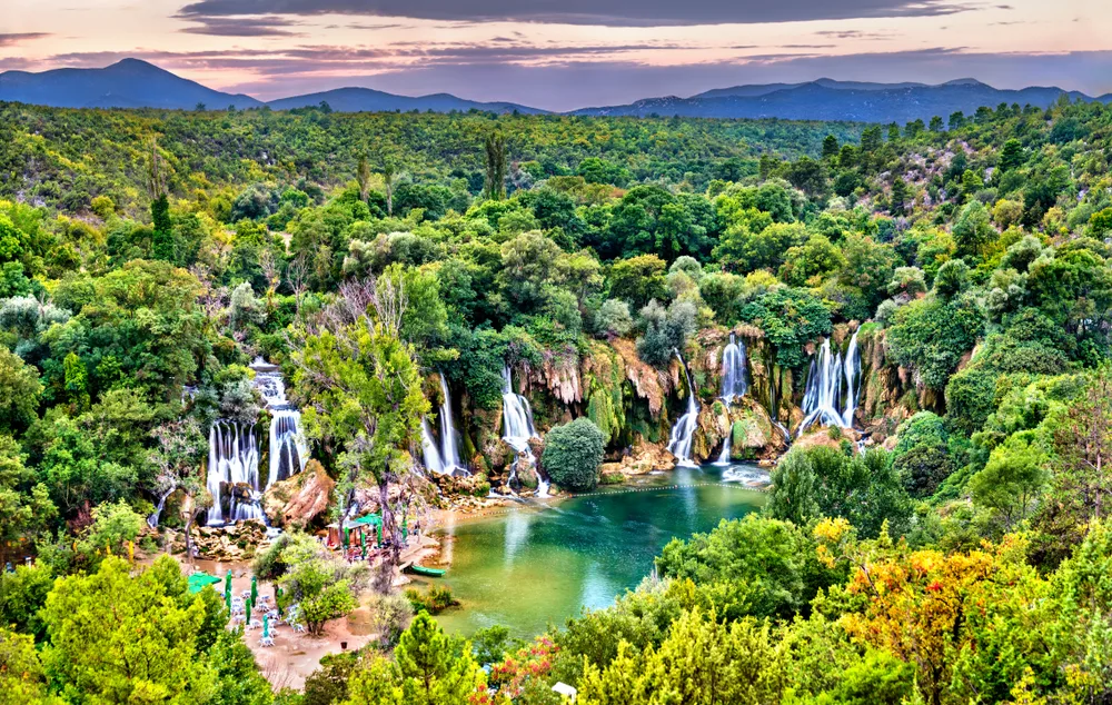 Aerial view of the Kravica waterfalls in summer with tourists enjoying the water during the best time to visit Bosnia