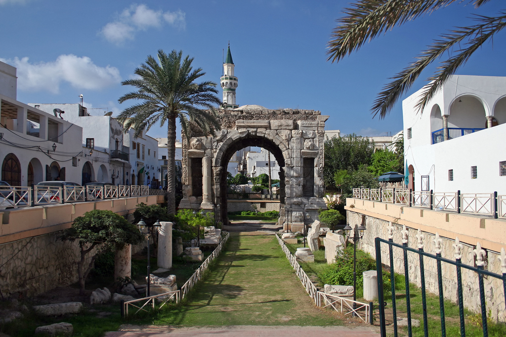 Arch of Marcus Aurelius, Roman emperor, with palm trees on a nice day during the least busy time to visit Libya