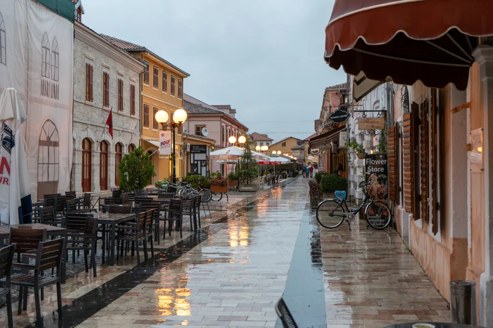 Empty street and dining tables in downtown Albanian city during winter shows the worst time to visit Albania