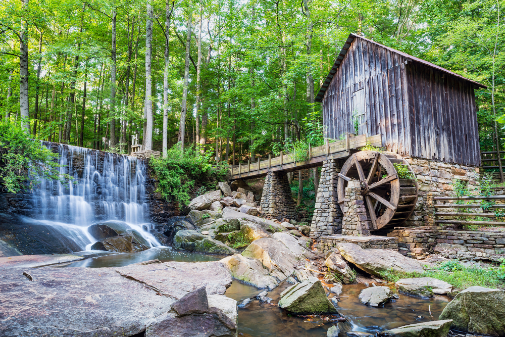 Historic waterfall and mill sitting on rocks in Marietta, a top pick for Georgia's best places to visit