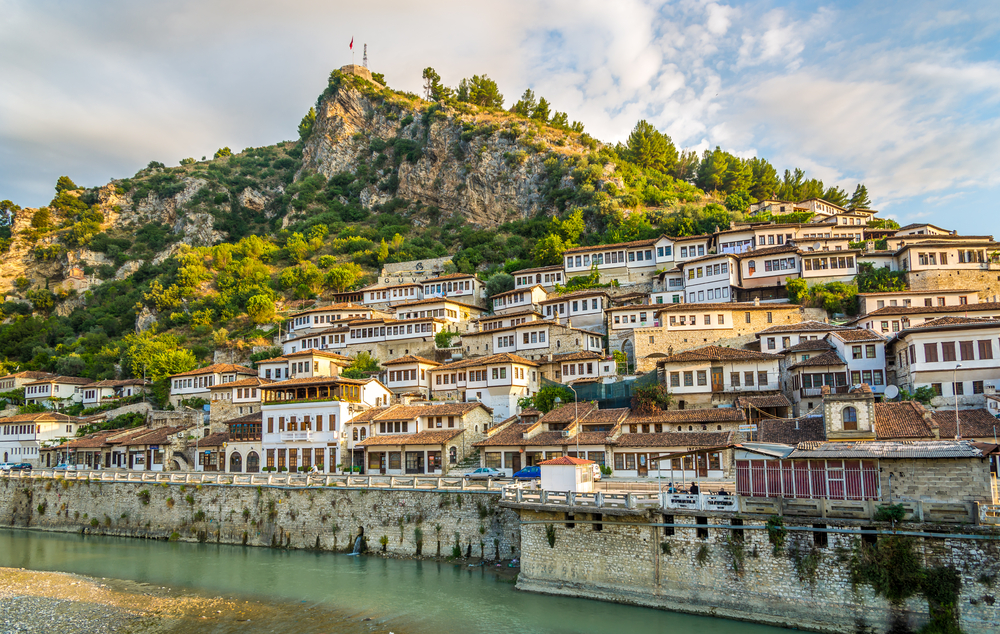 Old city of Berat with buildings on the hillside by the water show the least busy time to visit Albania