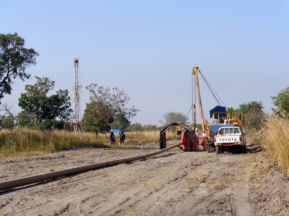 People in a white Toyota truck pictured installing an oil pipeline in Chad