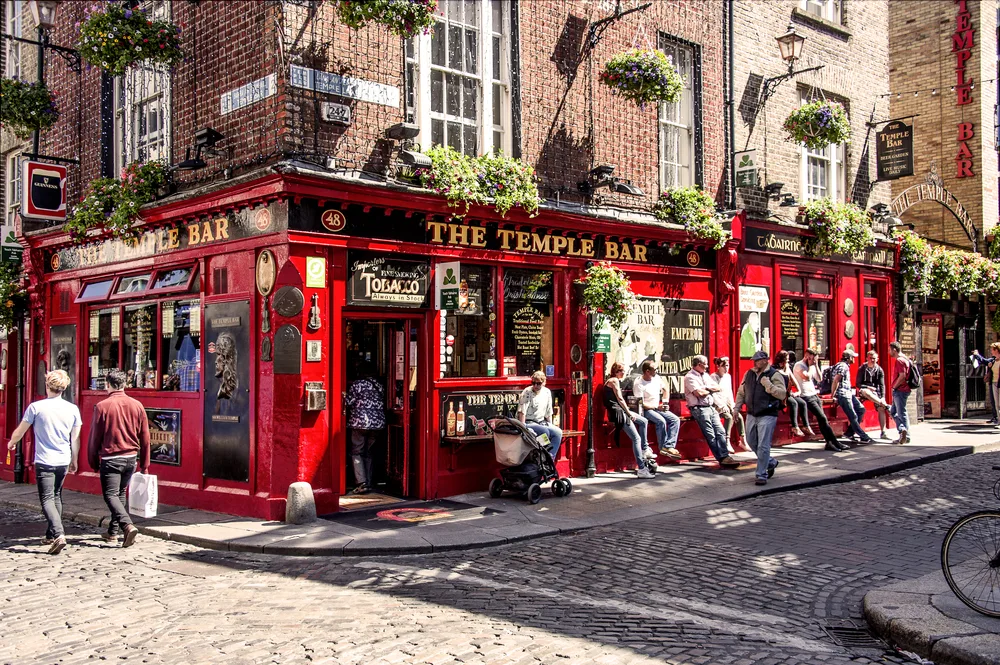 People relaxing in and around the Temple Bar area, one of the best places to stay in Dublin