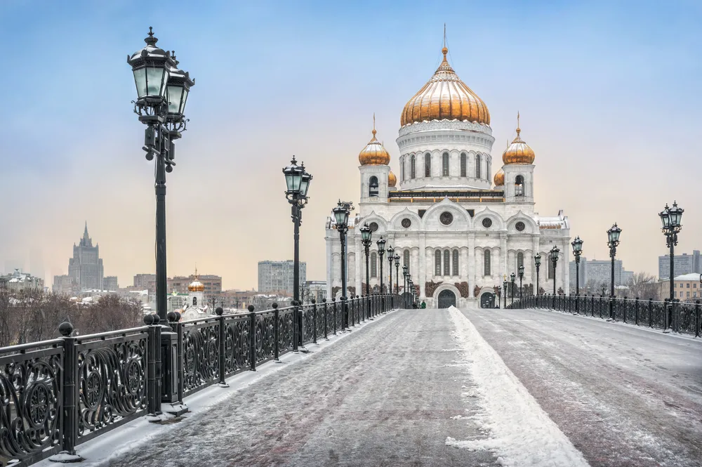 Snowy day in Moscow pictured for a piece answering whether the city is safe to visit with the Kremlin building seen from the Patriarchal Bridge