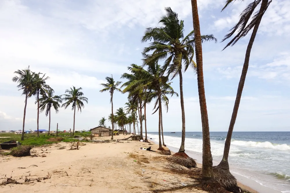 To highlight whether or not Nigeria is safe to visit, the Lekki Beach is pictured with its tan sand and tall palm trees running along the ocean