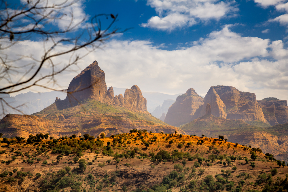 Distant view of the Simien Mountains National Park with clouds in the blue sky above during the best time to visit Ethiopia