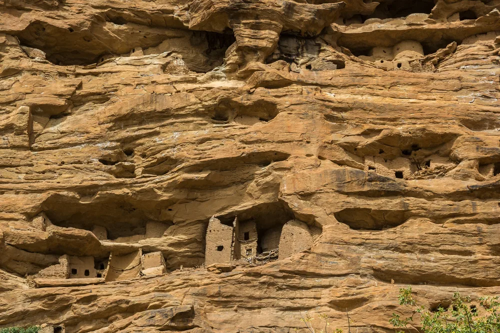 Dogon cliff houses and burial chambers in the rocks of the Bandiagara Cliff during the worst time to visit Mali