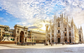 View of the Cathedral Duomo di Milano and Vittorio Emanuele Gallery in Square Piazza Duomo during the best time to visit Milan in spring and early summer with clouds in the sky as the sun rises
