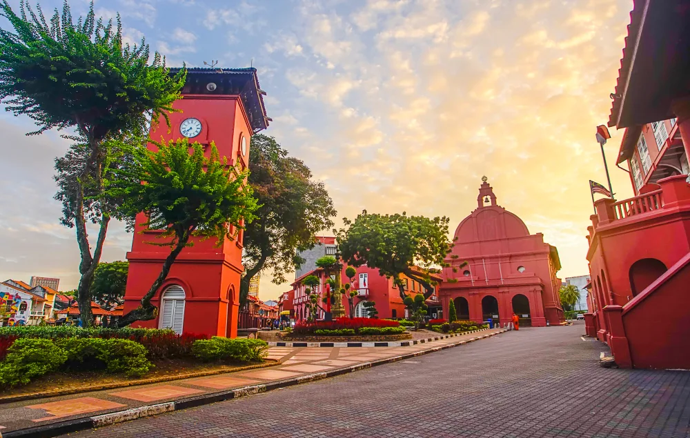 Oriental red building in Malacca pictured along a brick road for a piece titled Is Malaysia Safe to Visit