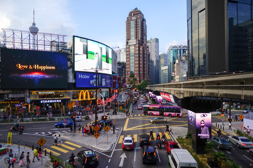 For a piece titled Is Malaysia Safe to Visit, a photo of the commercial shopping hub pictured from the Bukit Bintang monorail station