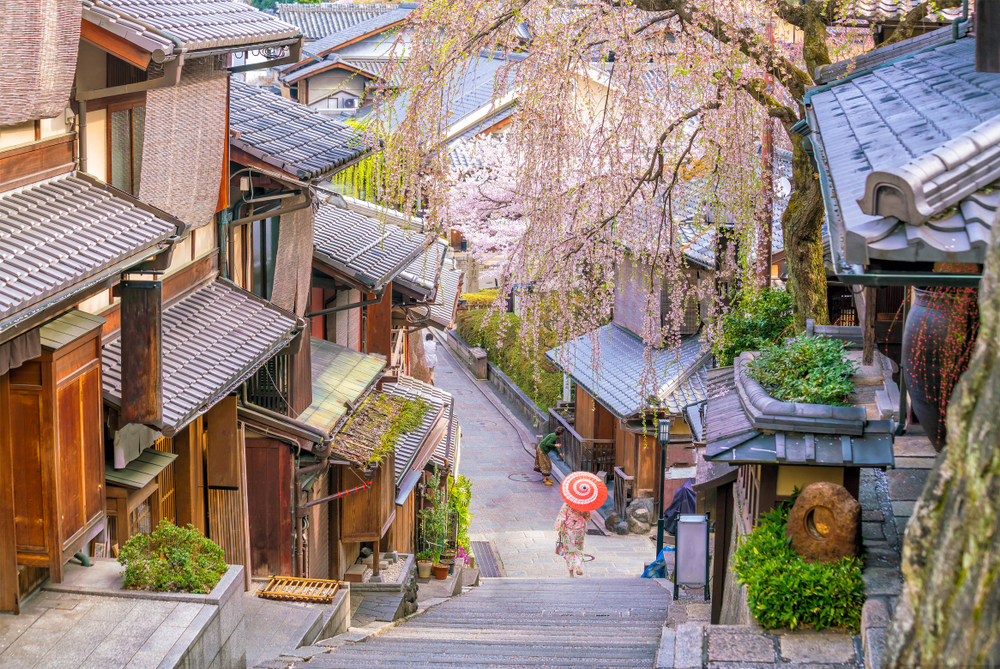 Photo of historic old homes in the Higashiyama District during the spring with cherry blossoms in full bloom for a piece titled is Kyoto Safe to Visit