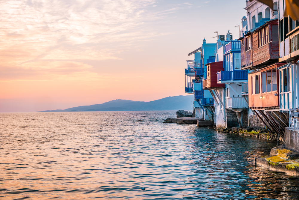 View of Little Venice houses and buildings by the water at sunset for a frequently asked questions section covering the best time to visit Mykonos