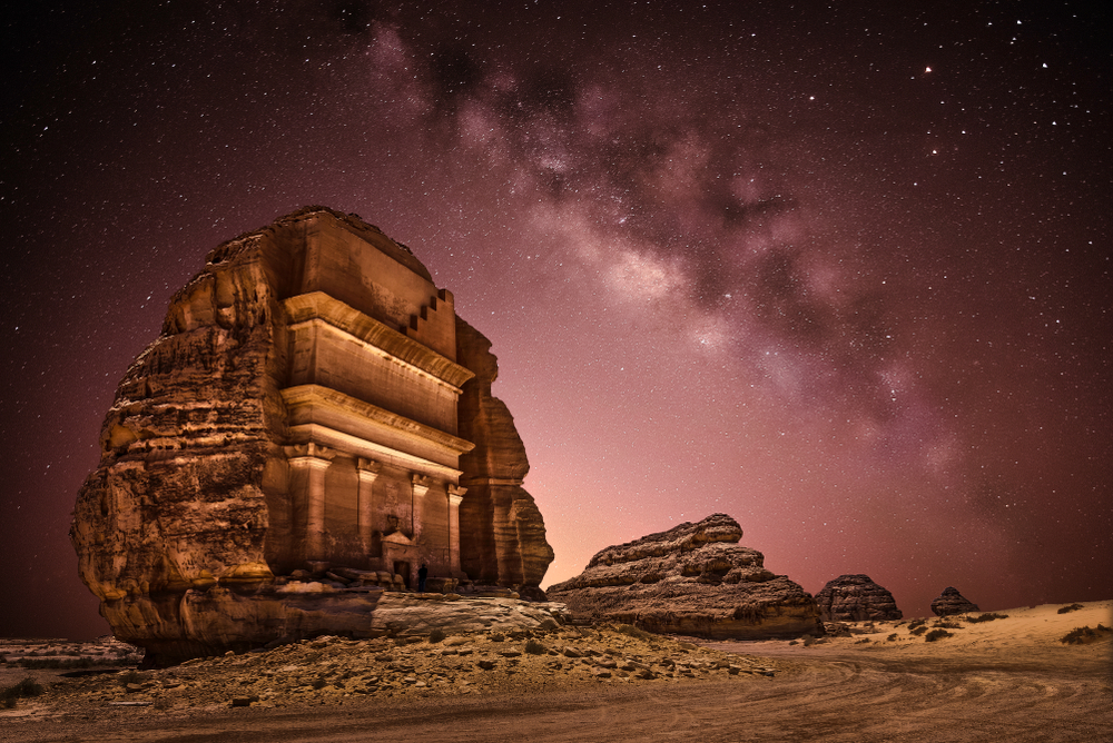 Mada'in Salih ancient rock carving shown at night lit from below in the desert during the least busy time to visit Saudia Arabia