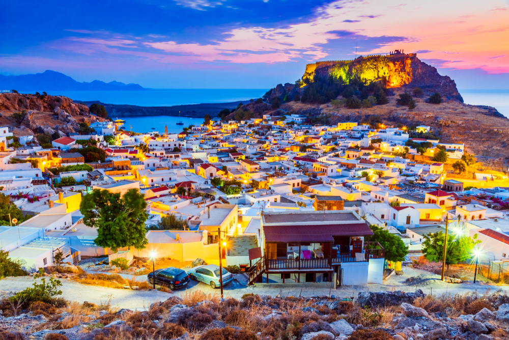 Photo of the Rhodes, Greece, town of Lindos with the Acropolis towering over the scene at night