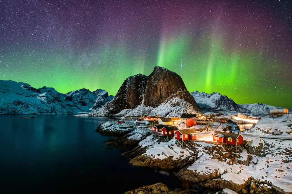 Gorgeous view of the green northern lights in Norway above Hamnoy