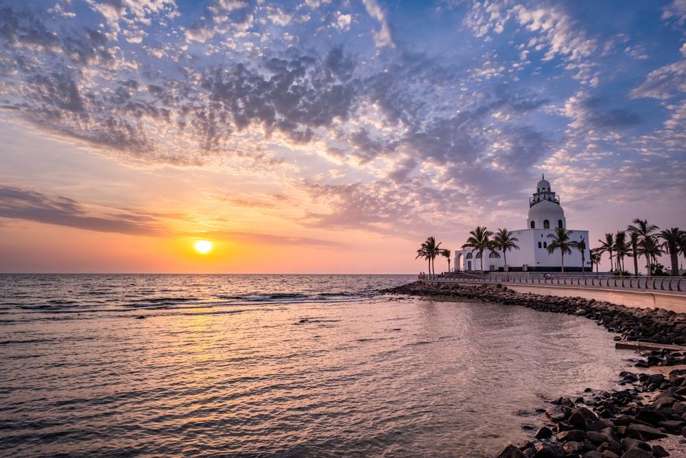 Jedda Corniche, a mosque on the Red Sea coast, at sunset on the beach shows the cheapest time to visit Saudi Arabia from October to December